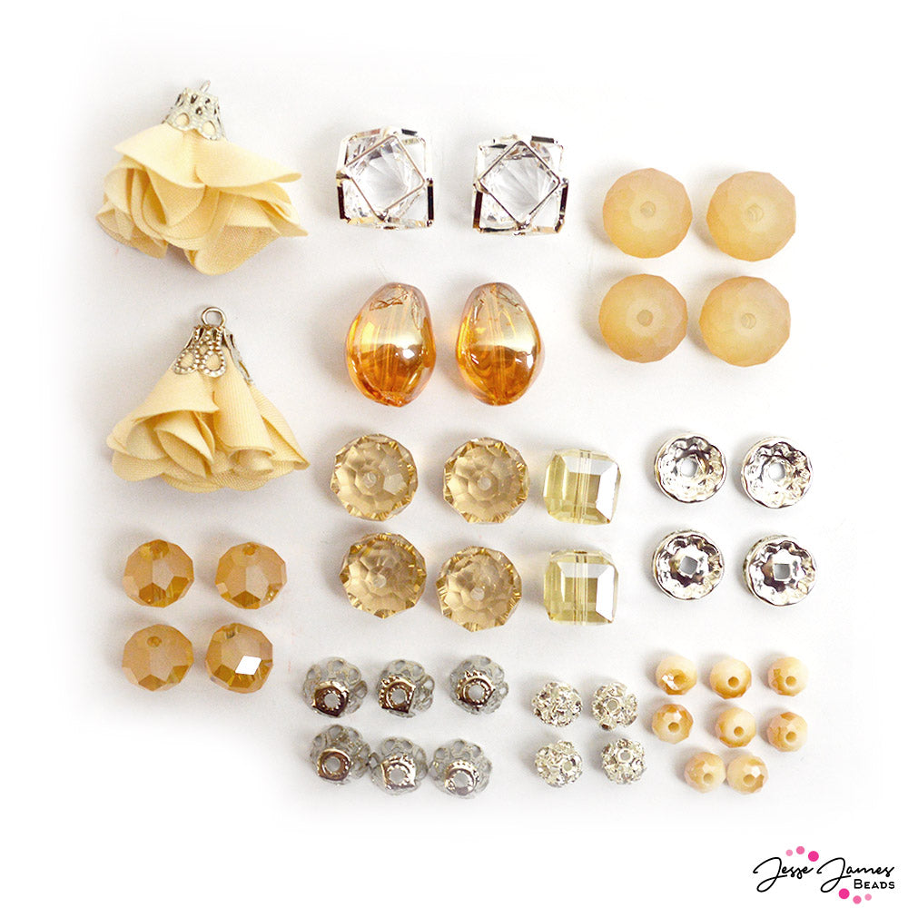 champagne beads from Jesse James Beads featuring faceted glass, caged crystals, bead caps, large tassels, and more.